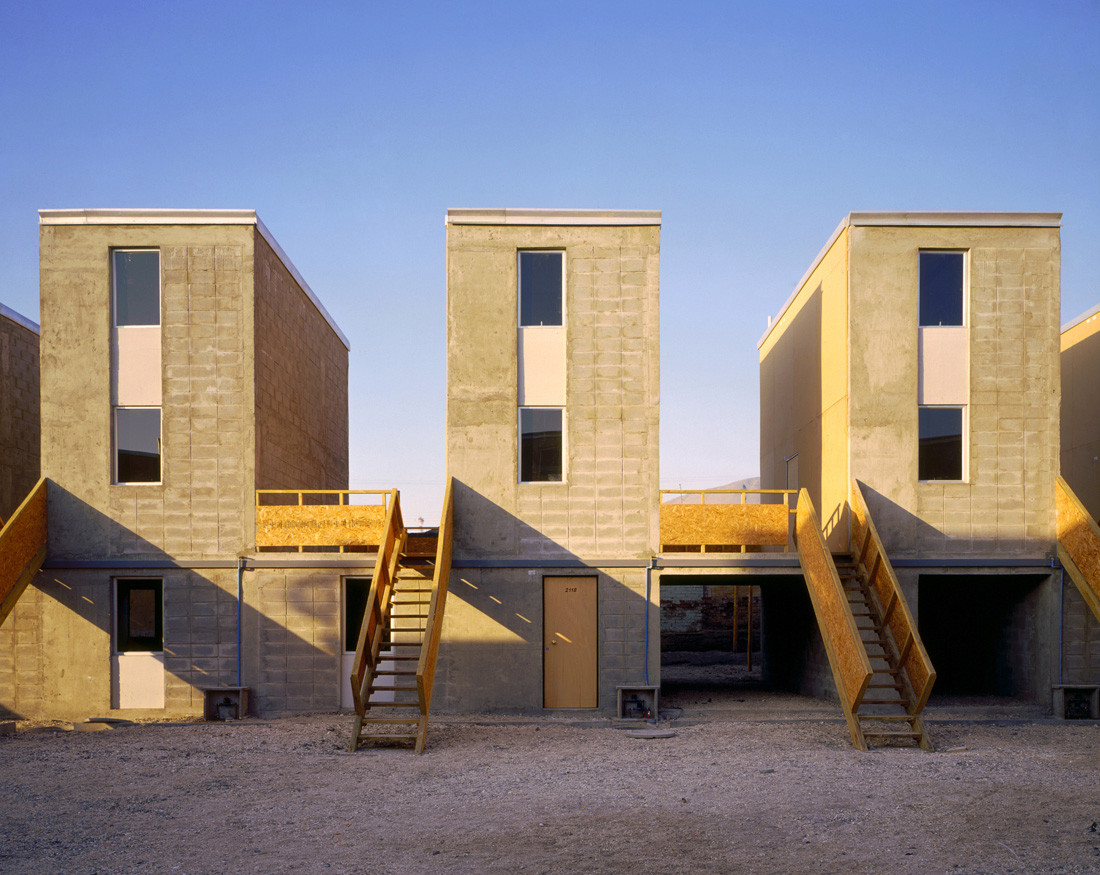 Quinta Monroy half-houses as delivered — concrete structure with timber staircases and expansion voids. Photo: Cristobal Palma